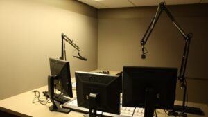 A microphone and mixing desk in a radio studio