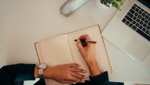 Notes and a laptop used to draft a business plan