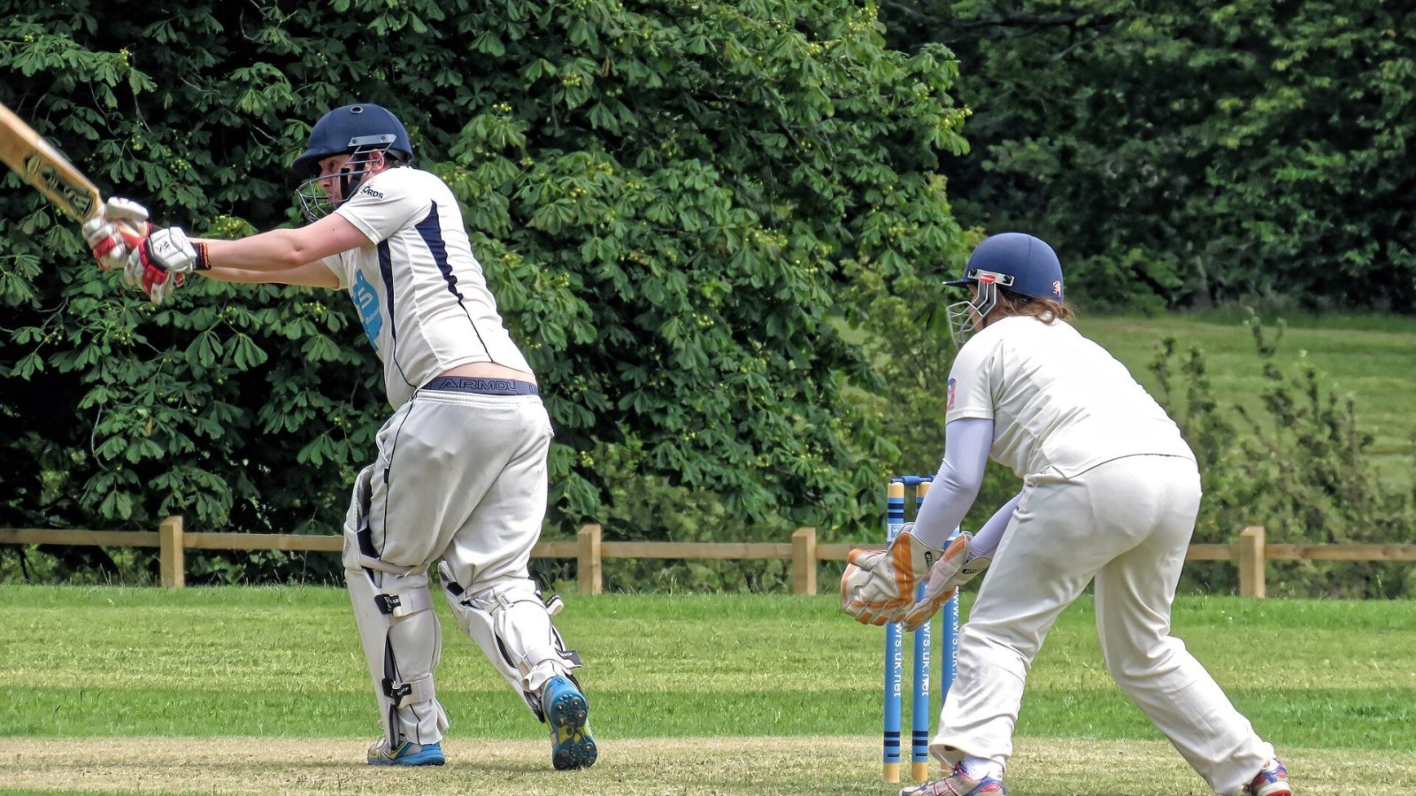 A batter playing a shot during a cricket match