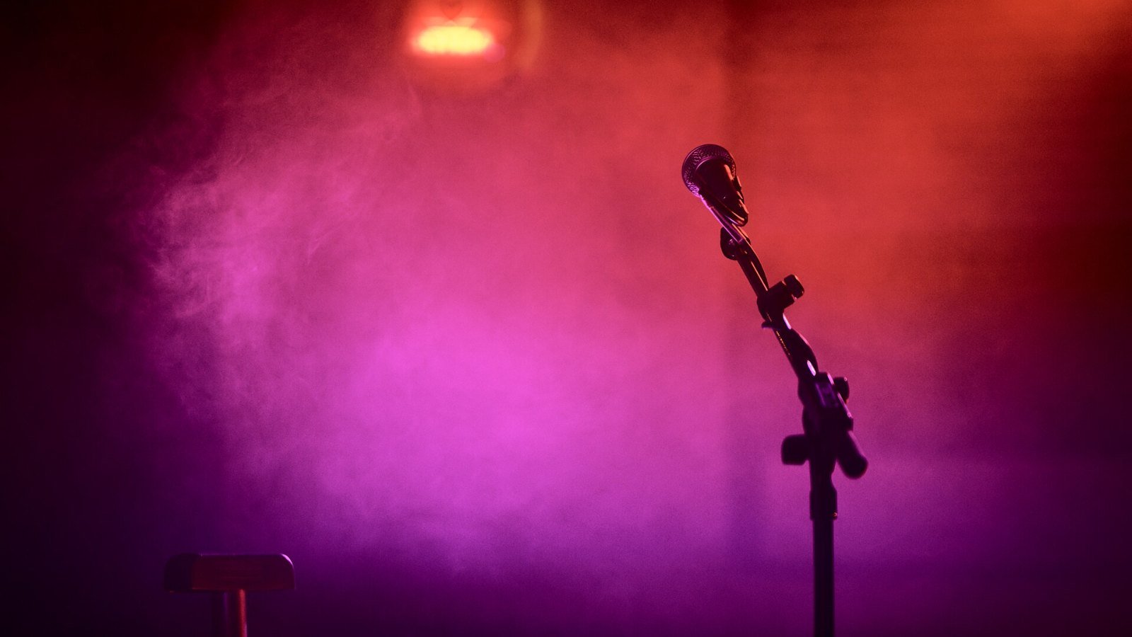 A microphone under coloured stage lighting