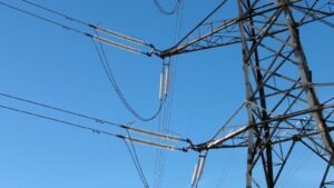 Electricity transmission pylons carrying power across open countryside